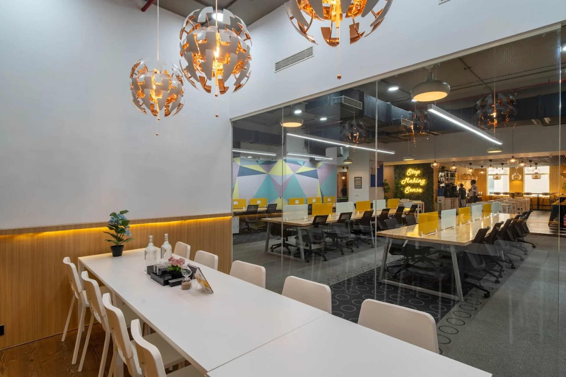 Oneskai office workspace with meeting tables and an open-plan work area